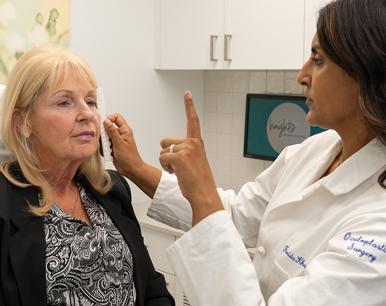 Dr. Femida Kherani examining patients face
