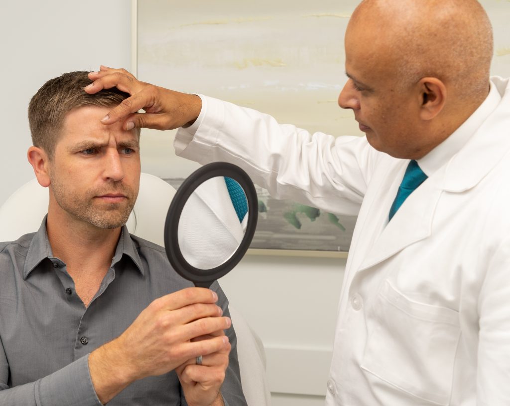 Dr. Jaffer performing a BOTOX consultation with a male patient
